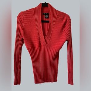 Festive, pumpkin colored, long sleeve sweater by United States Sweaters.